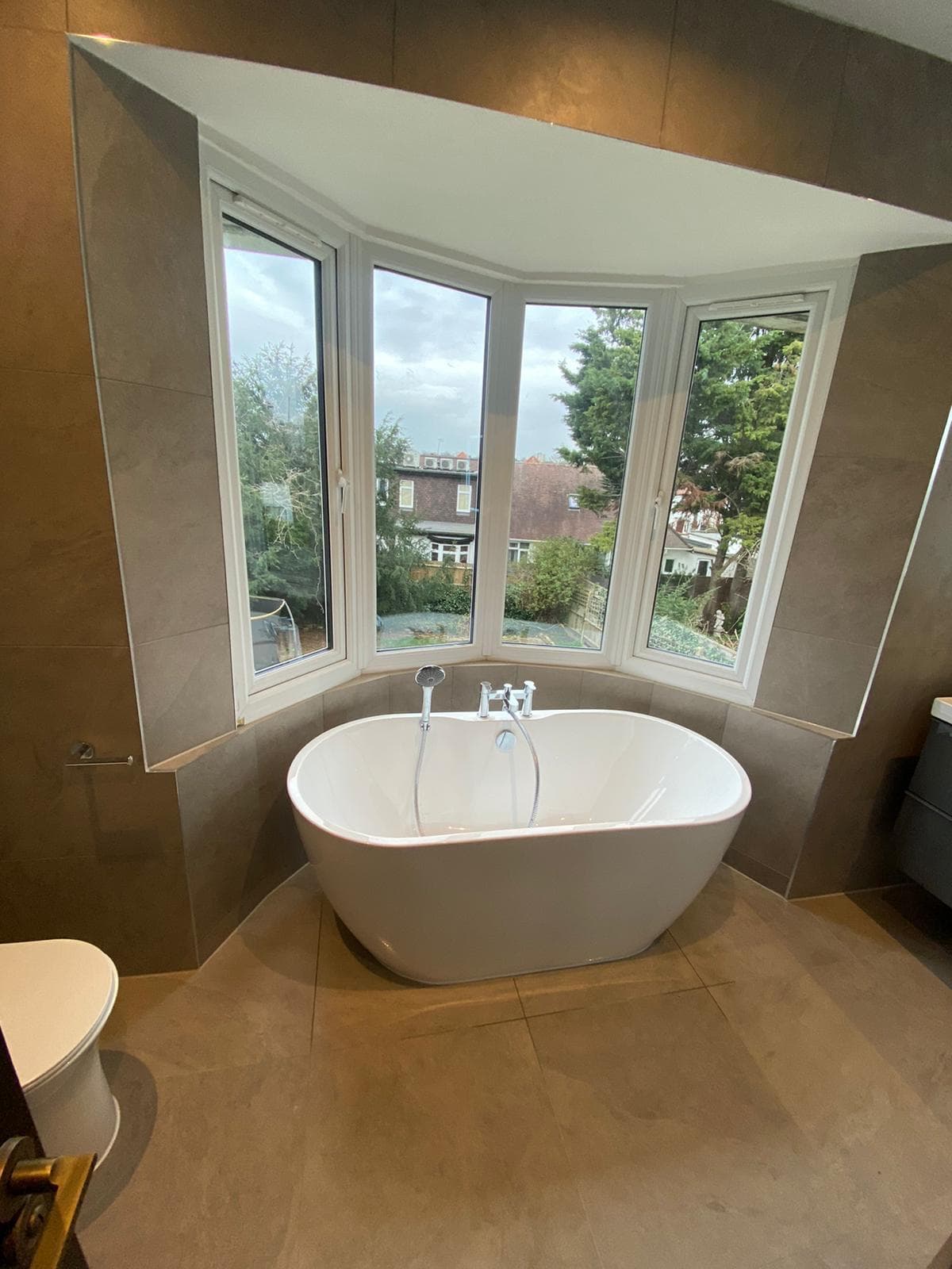 Luxury bathroom renovation with freestanding tub by BLT Building Contractors
